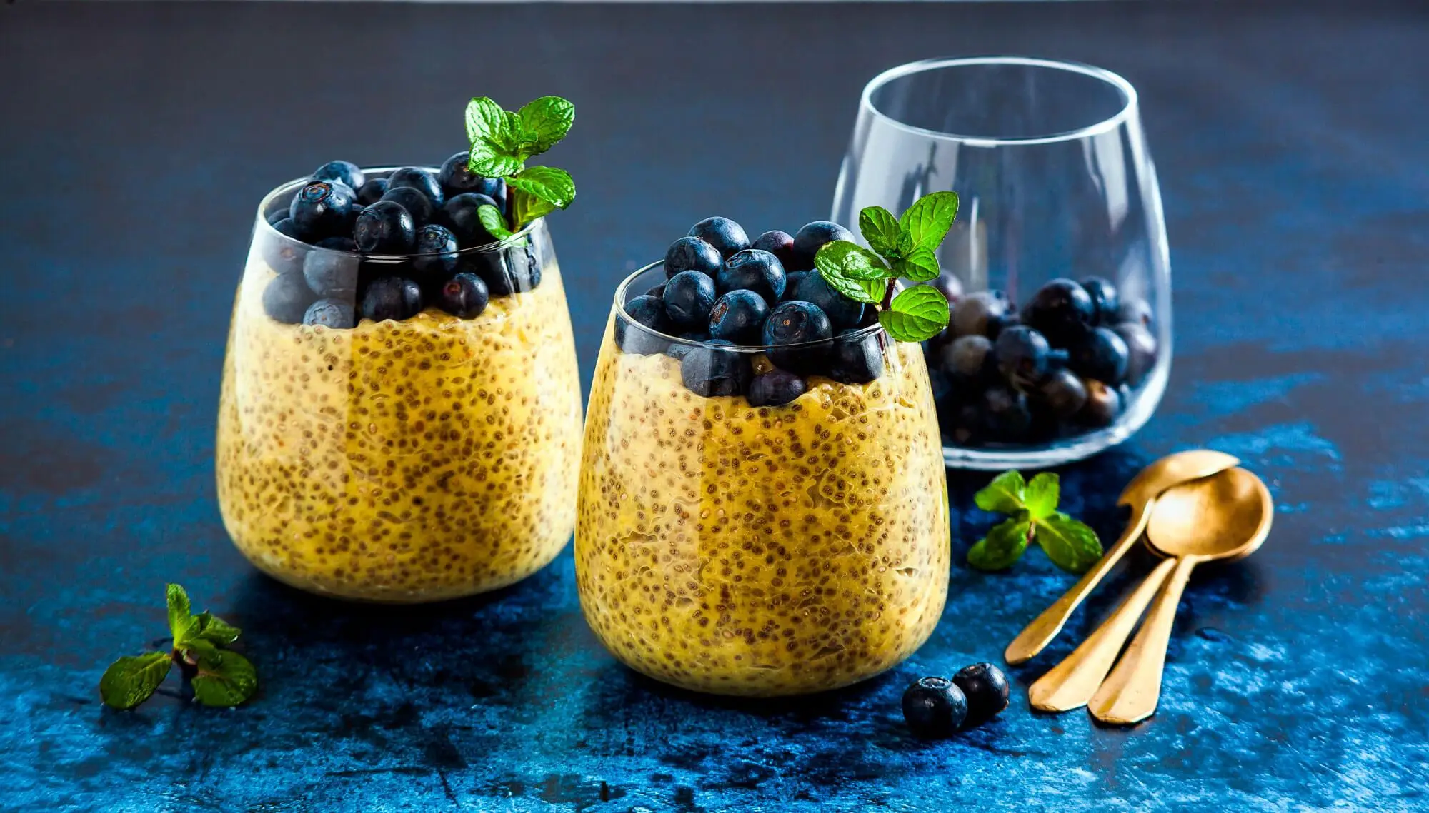 Chia seed and mango puree pudding with berries blueberry and mint