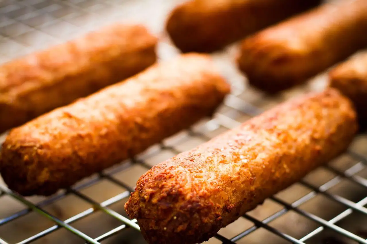 Close up of vegetarian soya protein sausages on a cooling rack