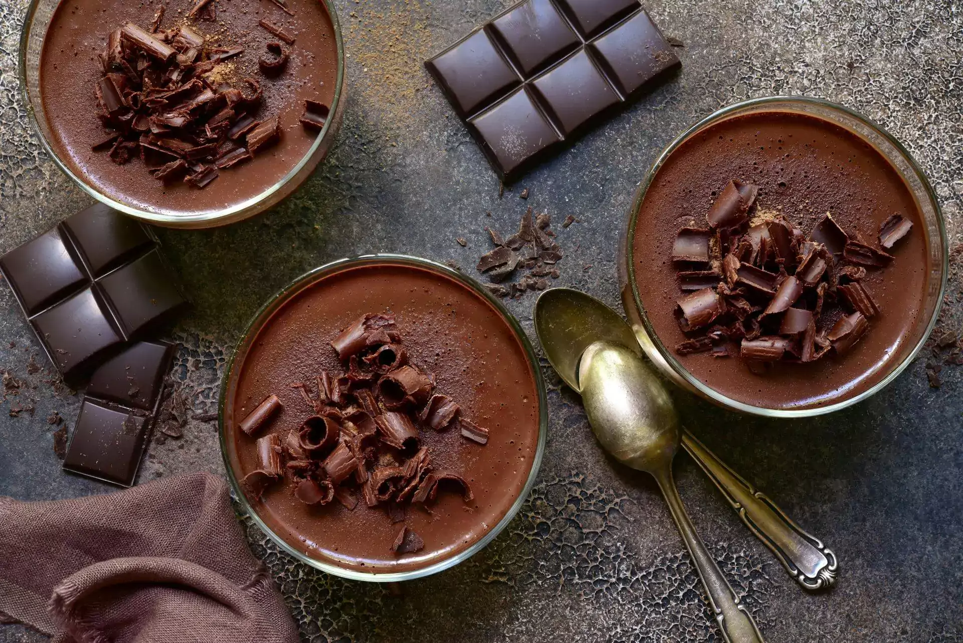 Delicious chocolate mousse in a glasses on a dark brown slate