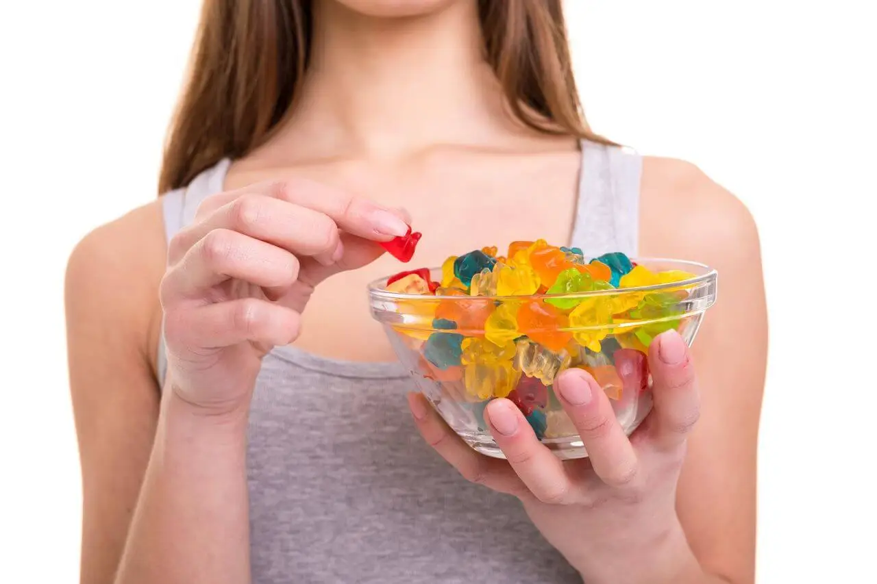 young woman holding a bowl of jelly gummy bears